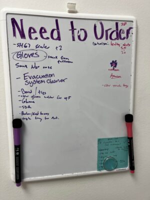 Whiteboard list of dental supplies to order