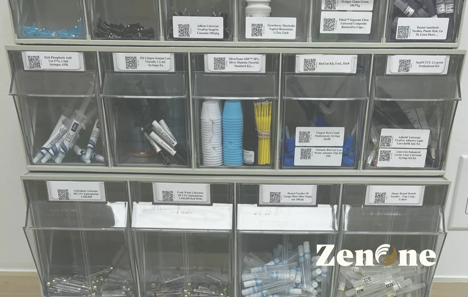 Photo of labeled clear storage bins filled with dental supplies (syringes, tips, cups, applicators) organized on shelving; ZenOne logo watermark in the lower right.