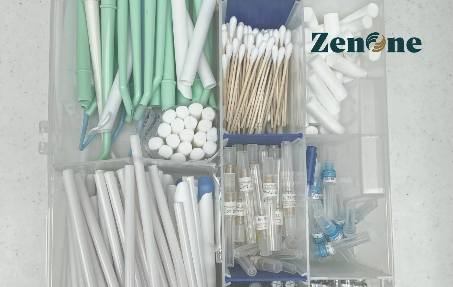 Image of various dental supplies in a plastic storage container